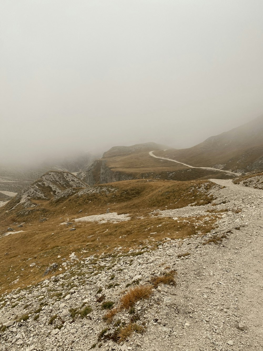 a rocky hillside with a road