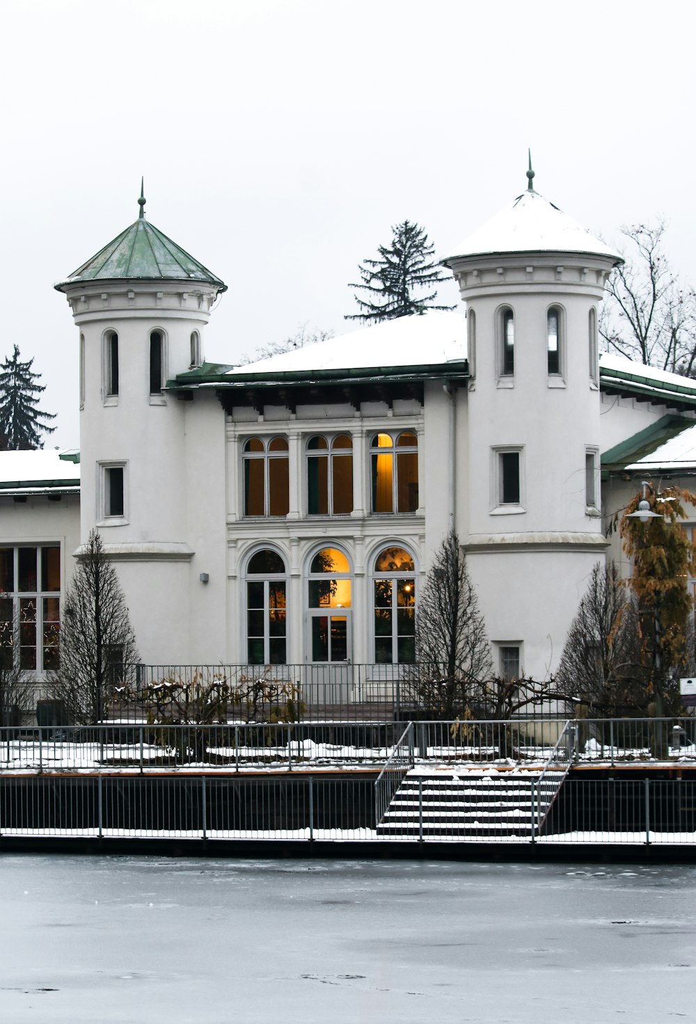 a white building with a green roof