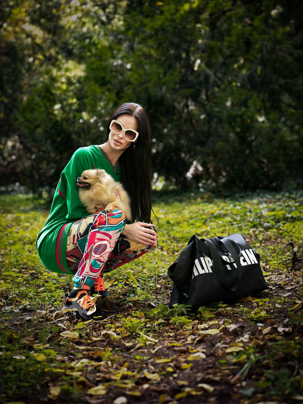 a person kneeling down holding a dog