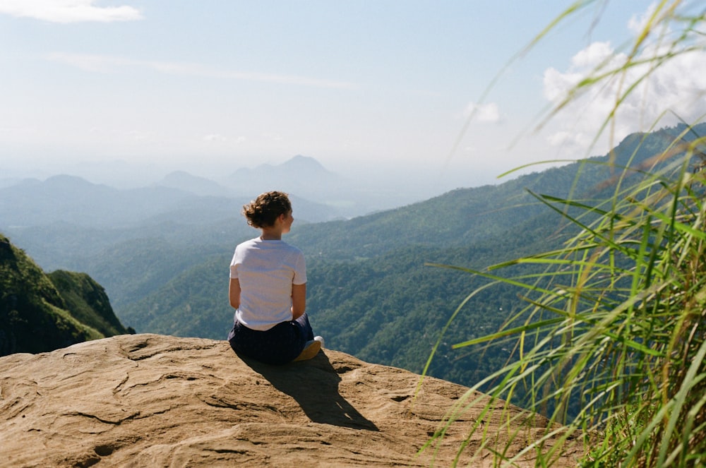 a man sitting on a rock