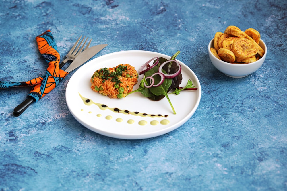 a plate of food and a bowl of food on a table