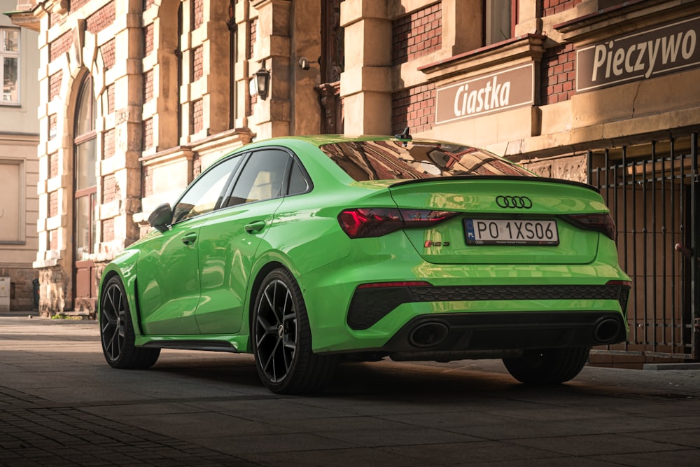 a green car parked on a street