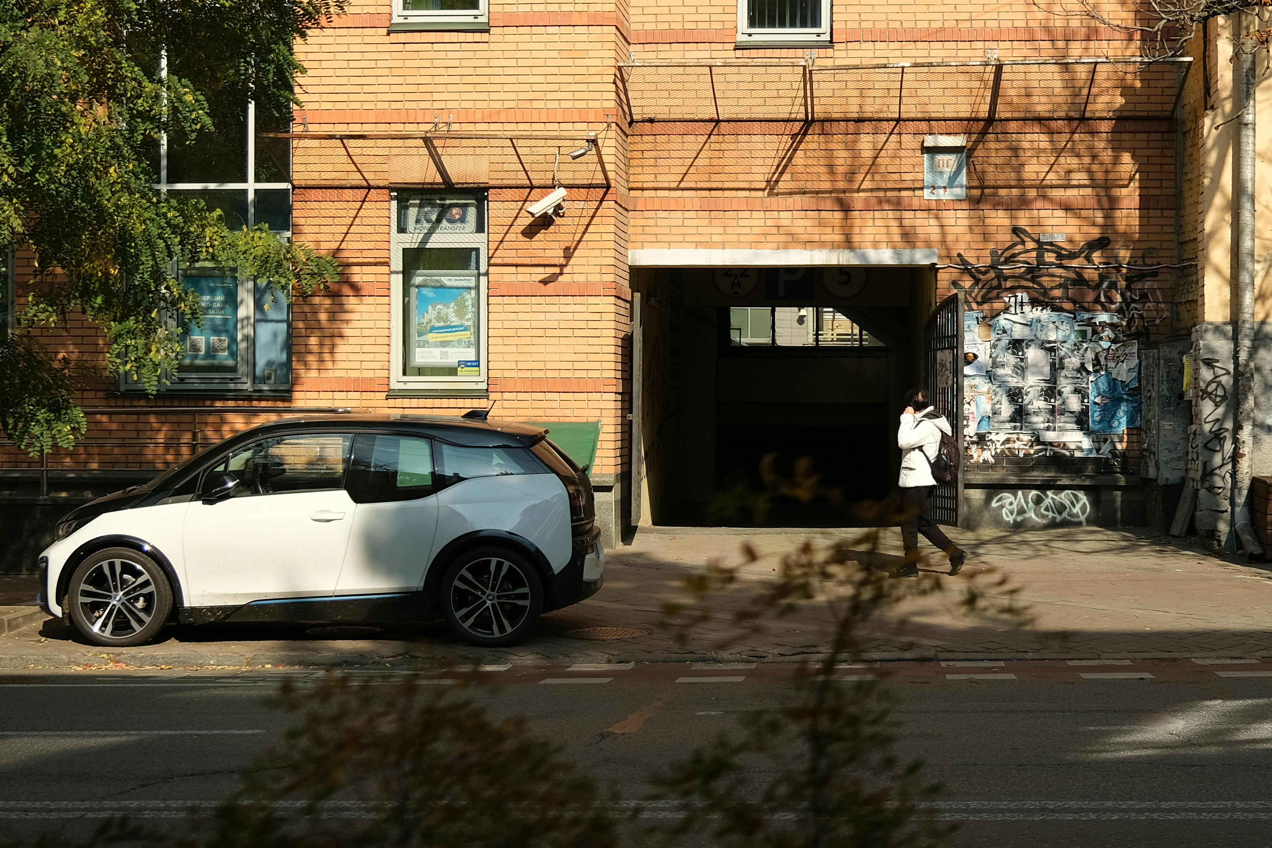 a car parked in front of a building with graffiti on it