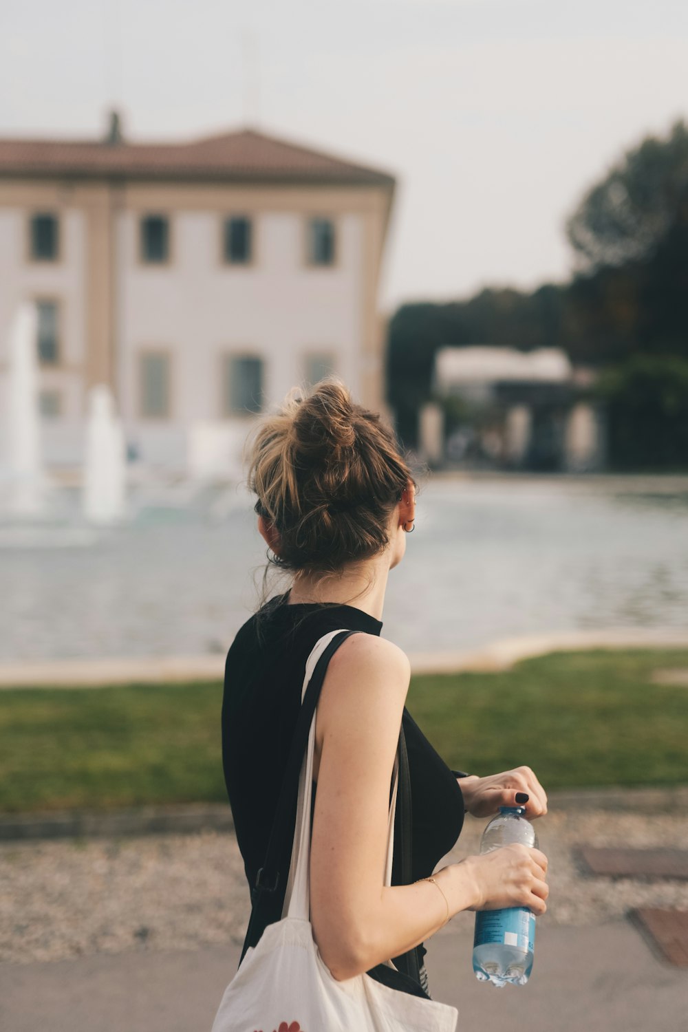 a woman holding a water bottle