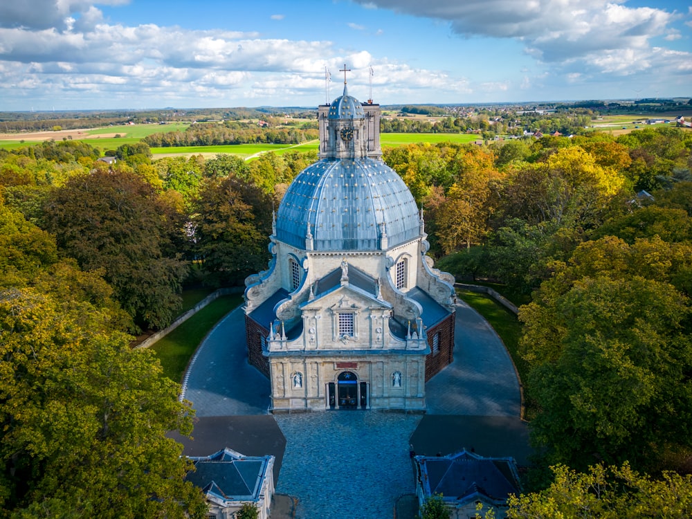 a building with a dome on top surrounded by trees