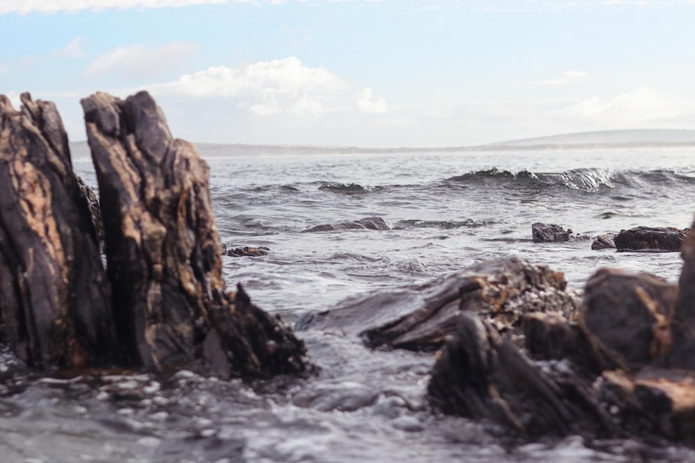 a rocky beach with waves crashing