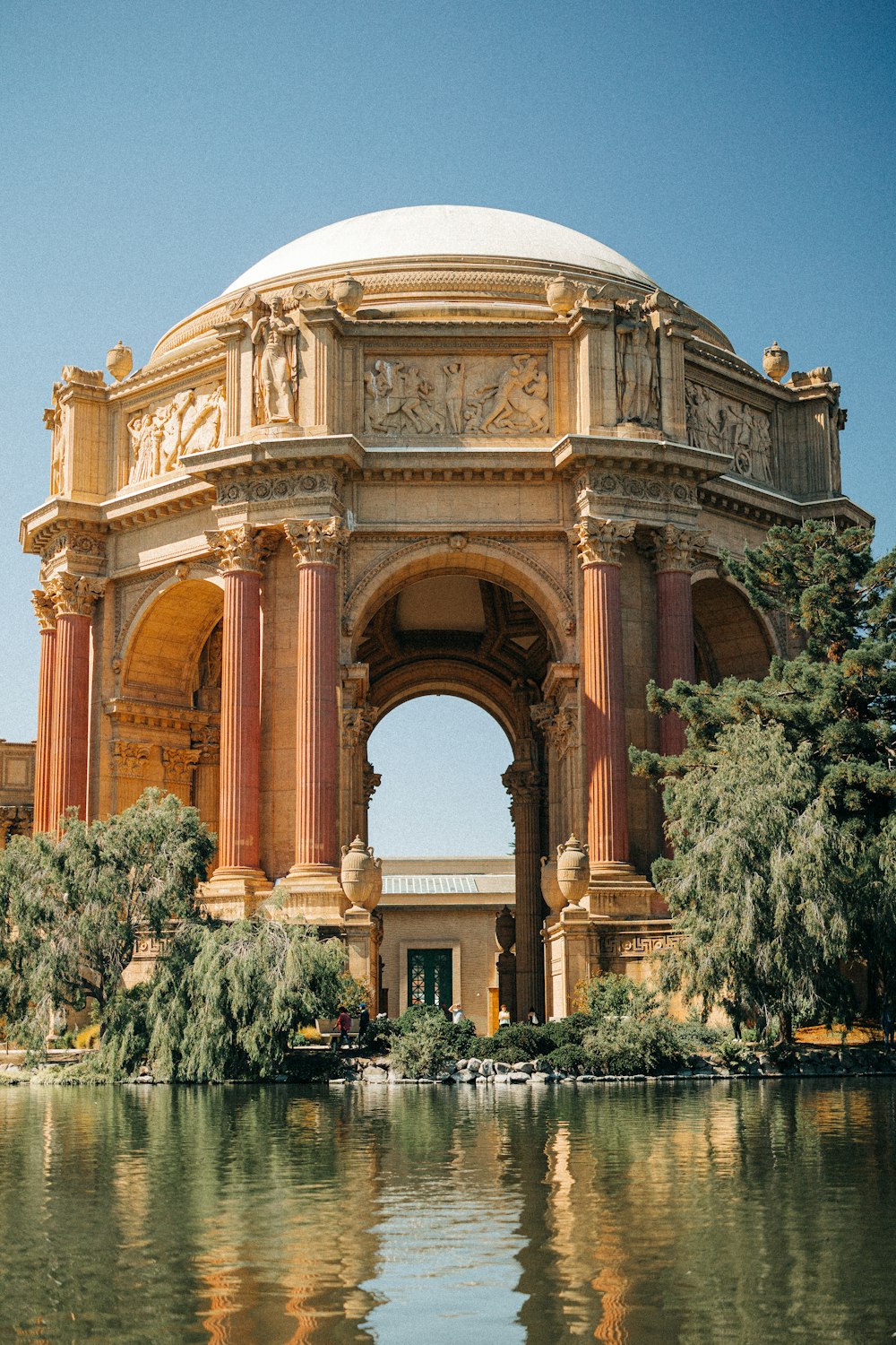 a large stone building with columns with Palace of Fine Arts in the background