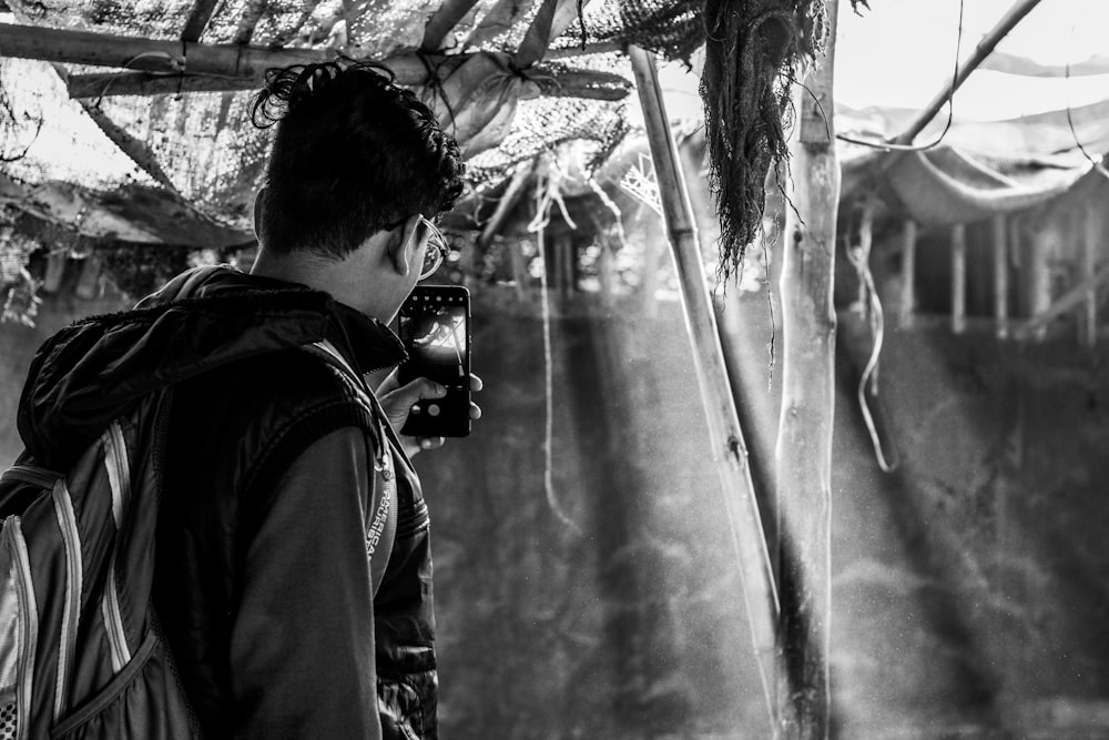 a man taking a picture of a waterfall