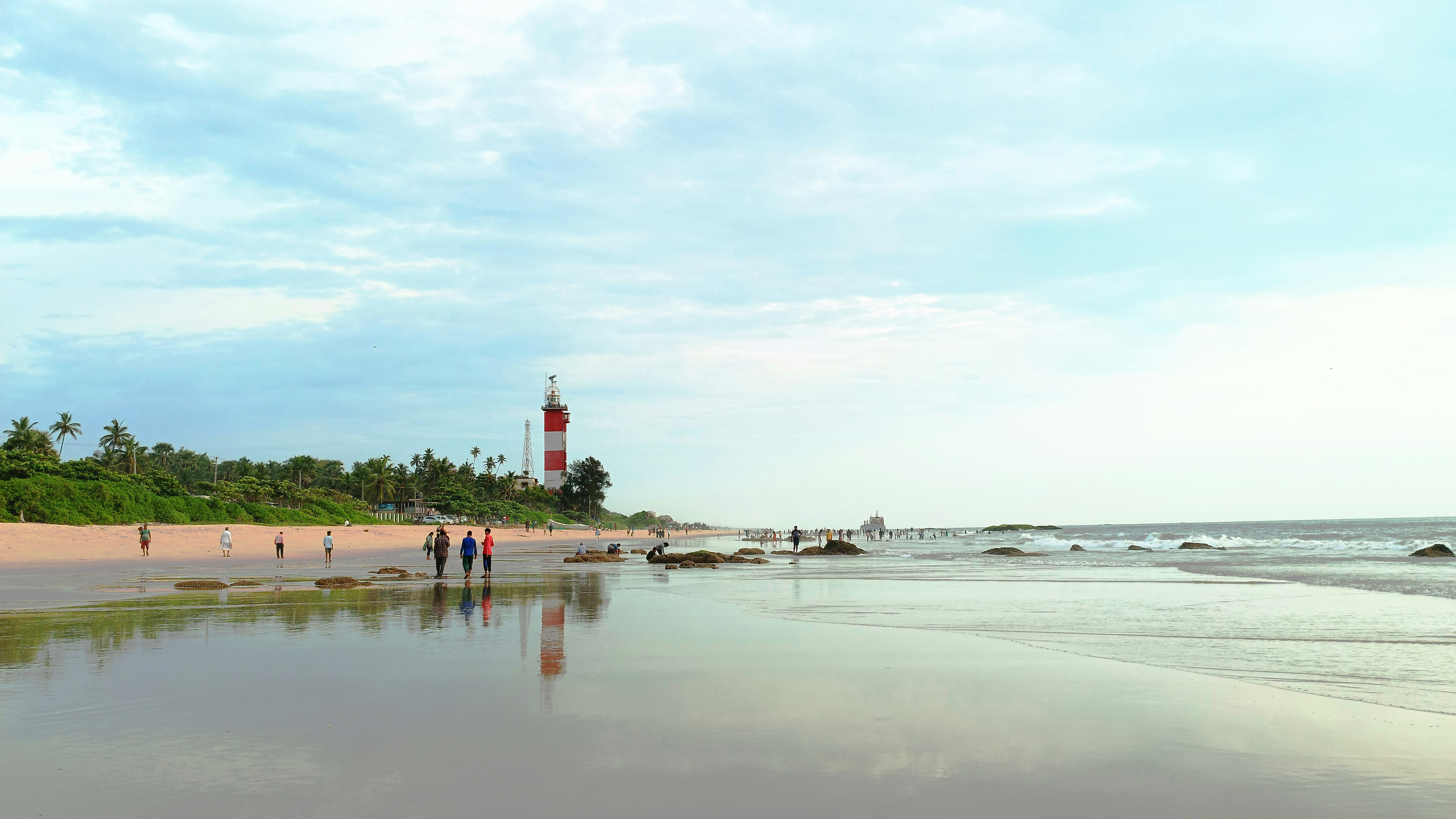 a group of people walking on a beach