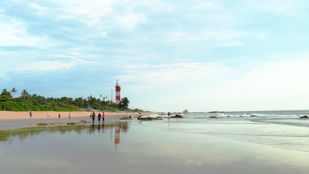 a group of people walking on a beach