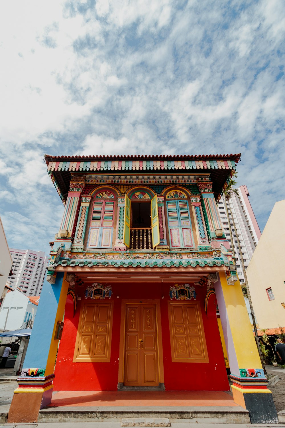 a colorful building with a red door