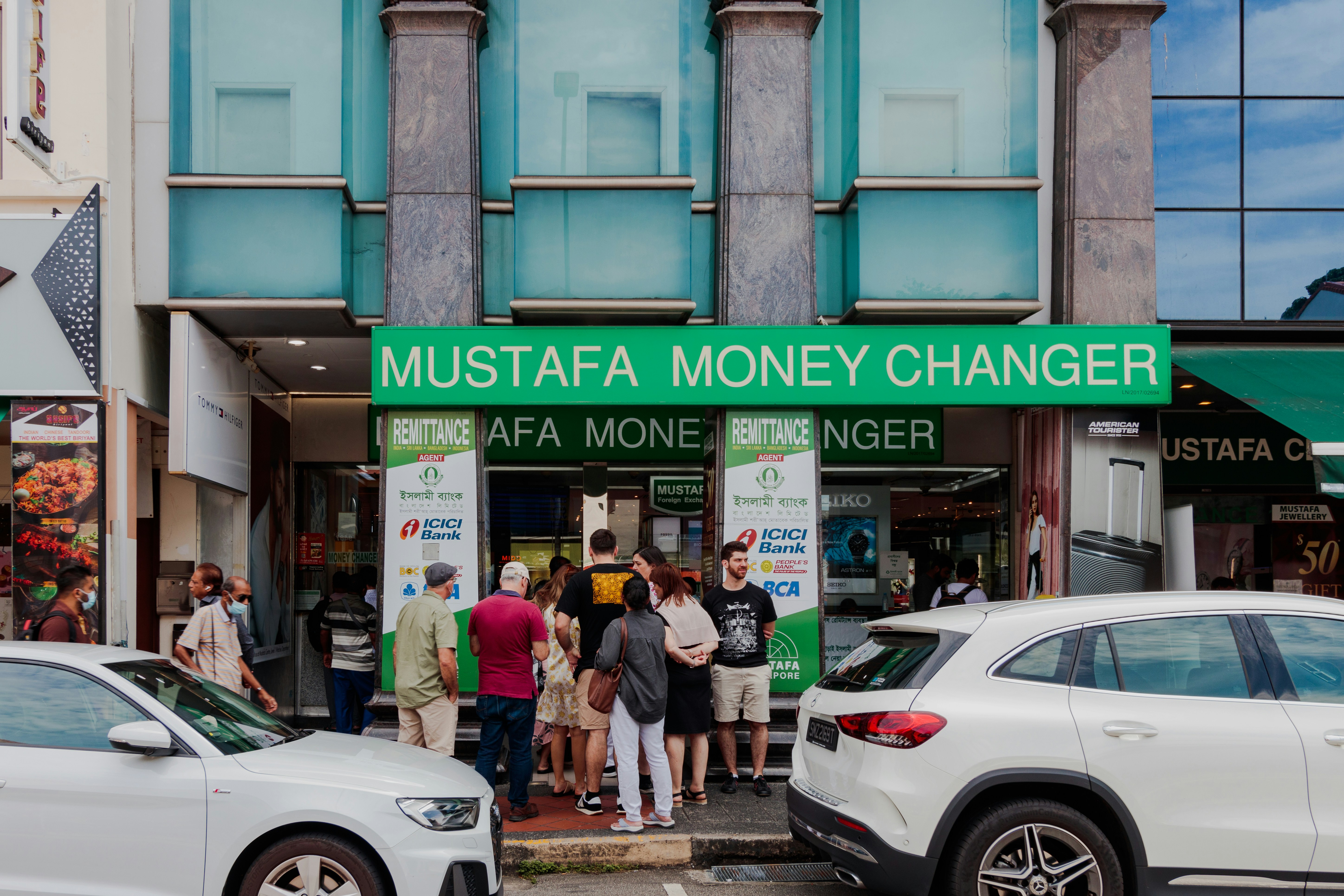 a group of people standing outside a store