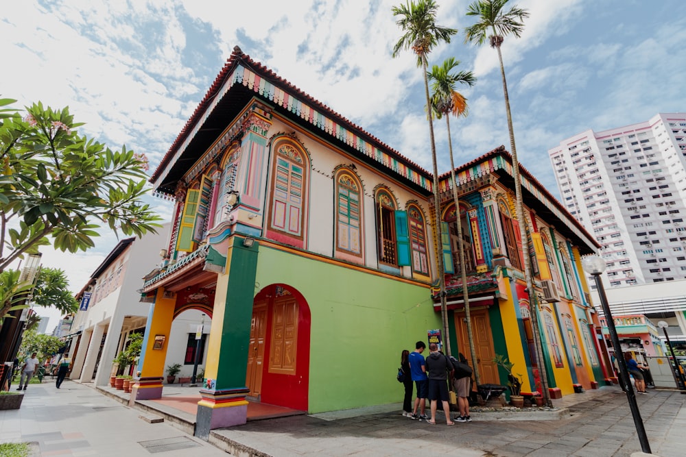 a colorful building with a group of people standing in front of it