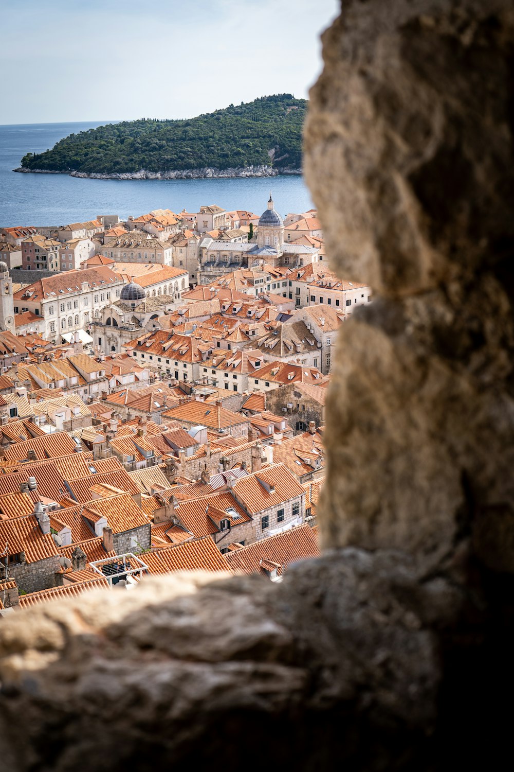 a city with red roofs by the water