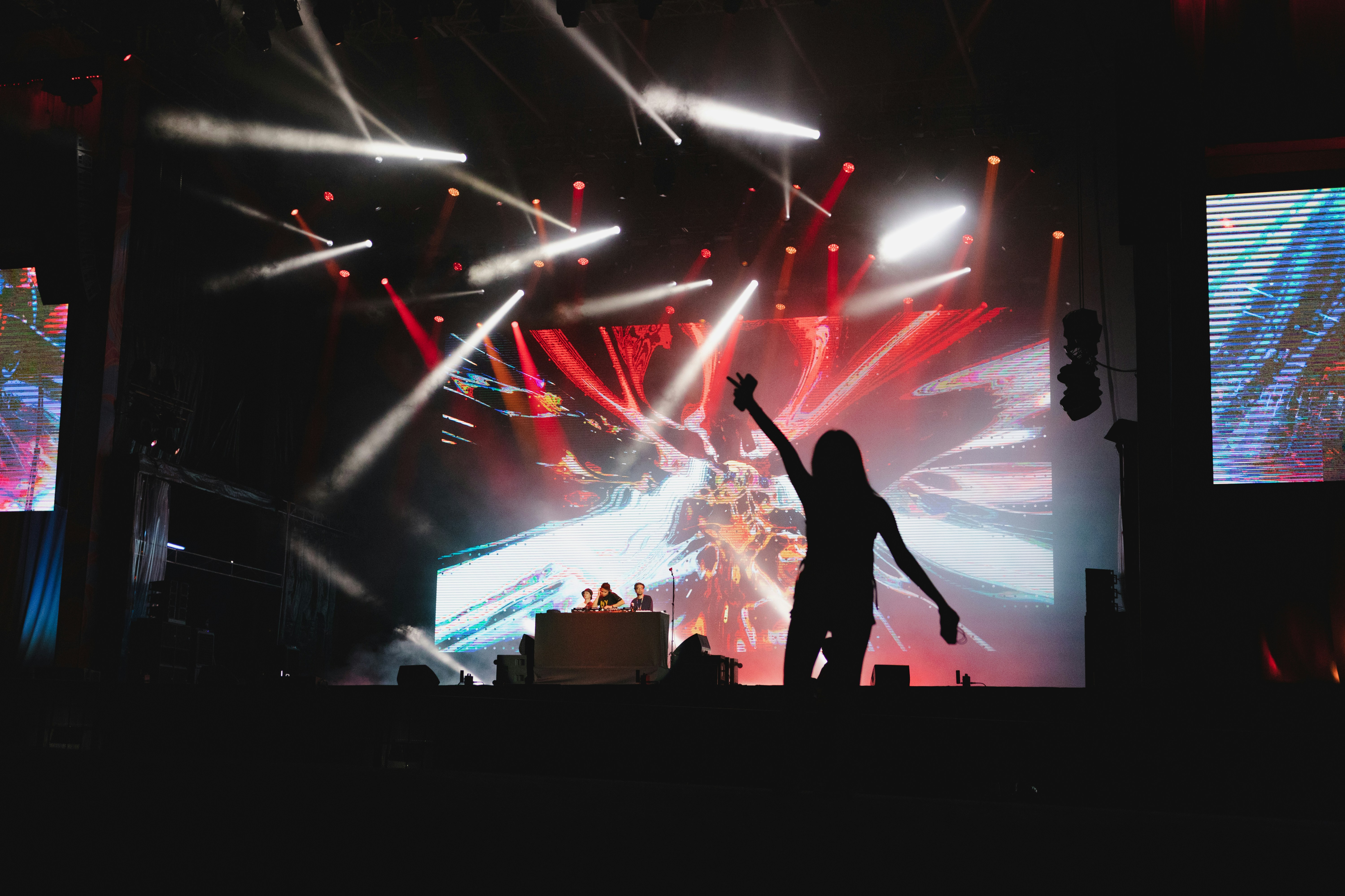 a person on a stage with a crowd watching, 