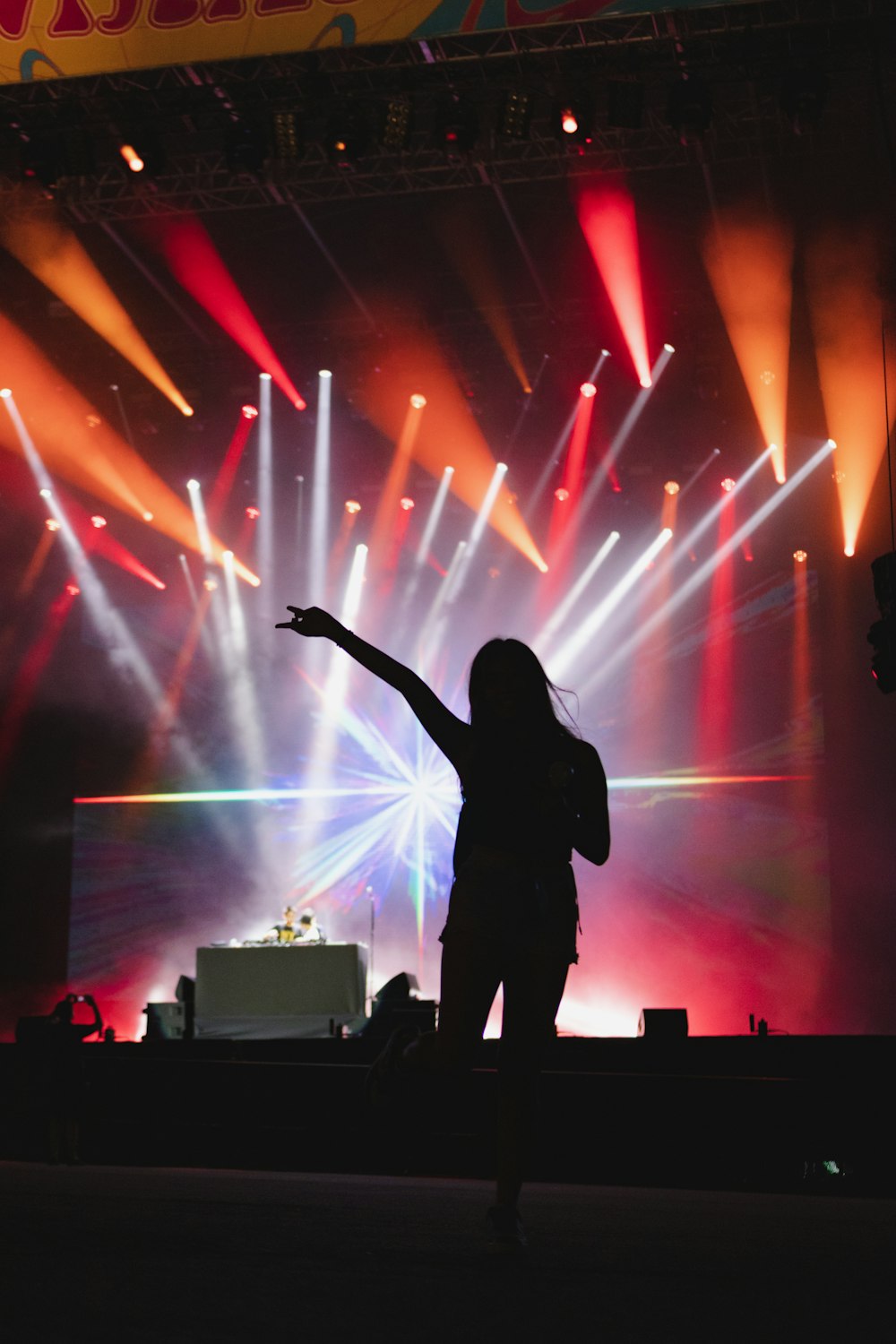 uma pessoa em um palco com um microfone e luzes