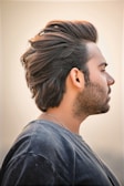 Profile view of a stylish haircut with a defined hairline and textured top.