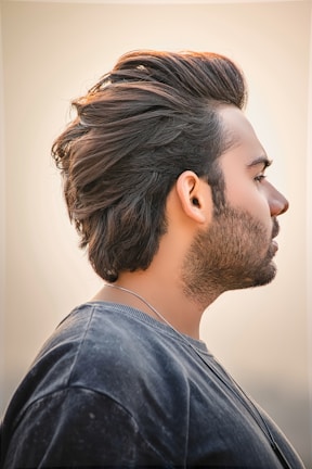Profile view of a stylish haircut with a defined hairline and textured top.