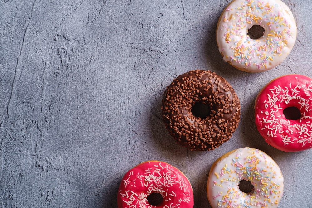 a group of donuts with sprinkles on them