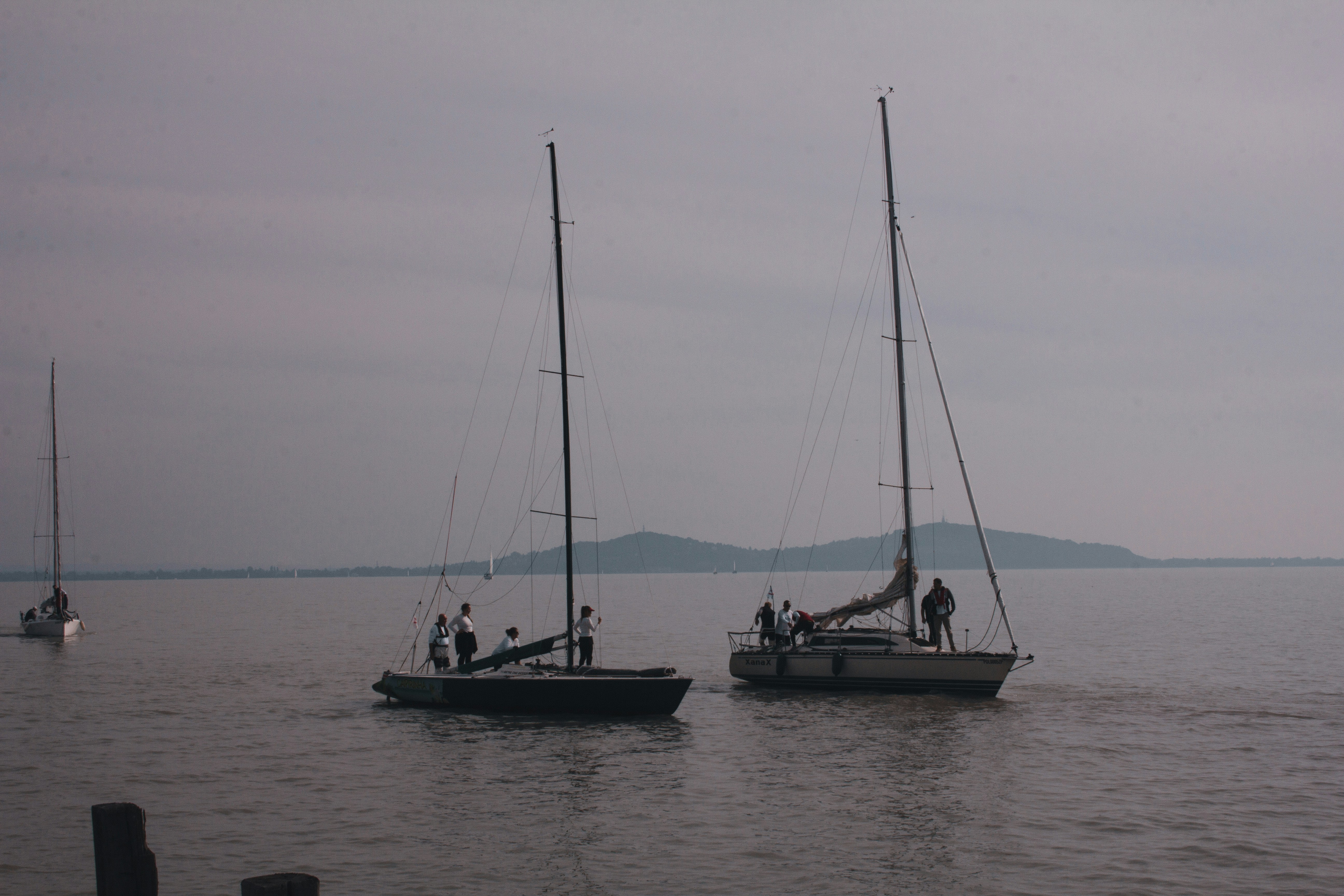 a group of sailboats on the water