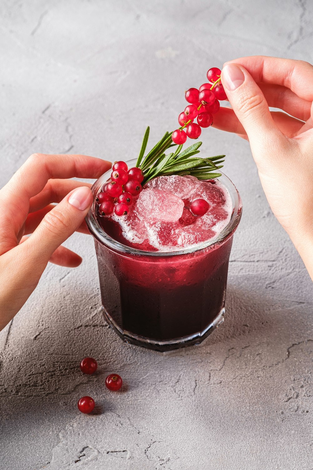 a person holding a cup of strawberry jam