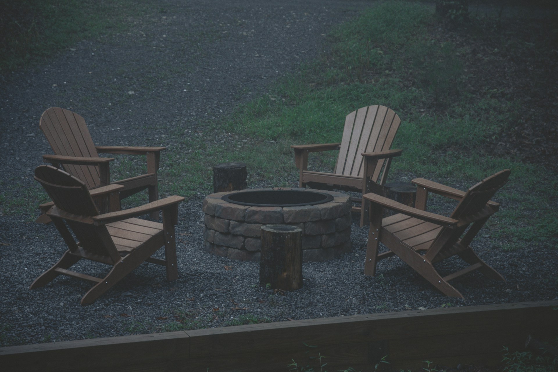 a group of chairs around a fire pit