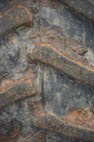 Close-up of heavy-duty tires on a skid steer, covered in mud from recent work.