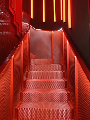 Staircase lighting fixture highlighting metal and electronic components.