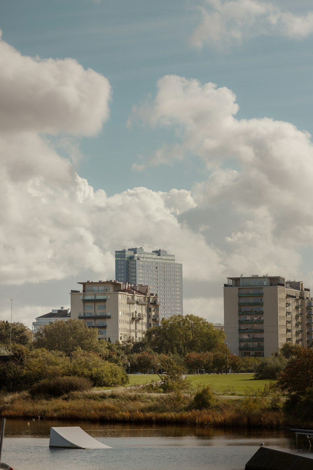 a body of water with buildings in the background