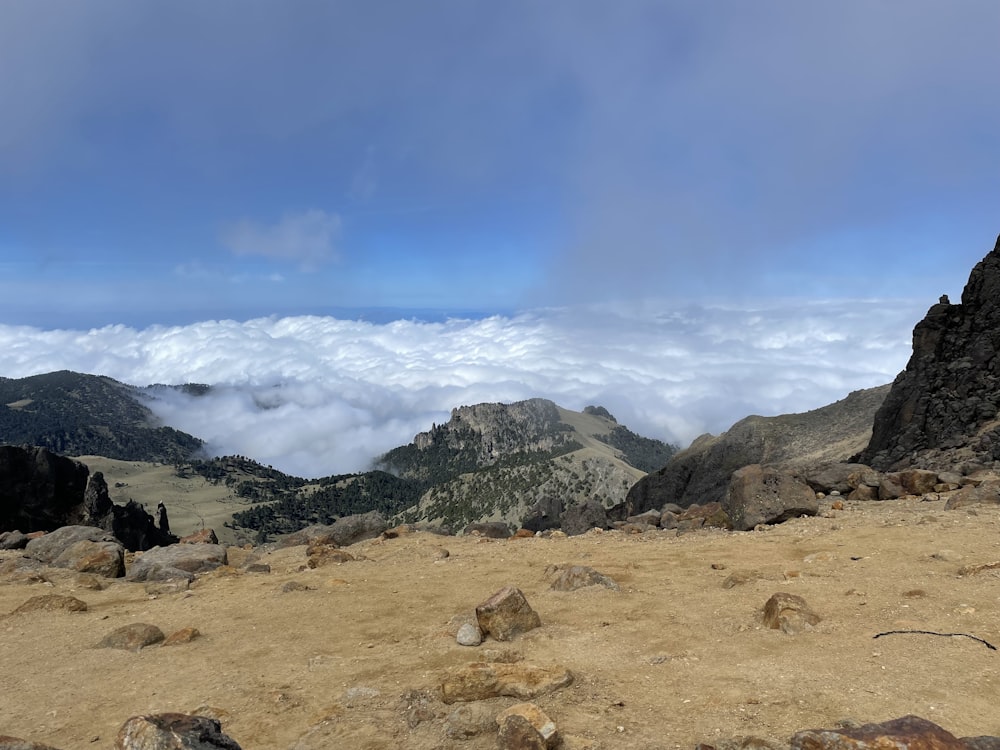 a rocky landscape with mountains in the background