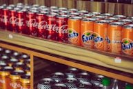 a shelf with cans of soda on it