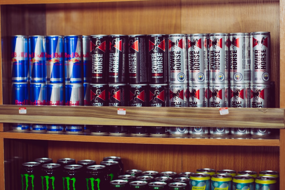 a shelf with many cans of beer on it