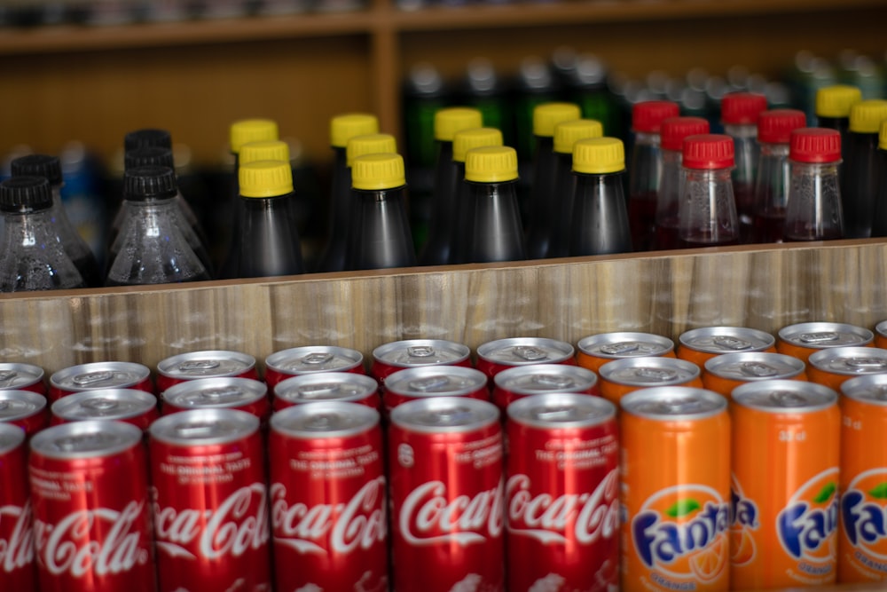 a shelf of soda cans