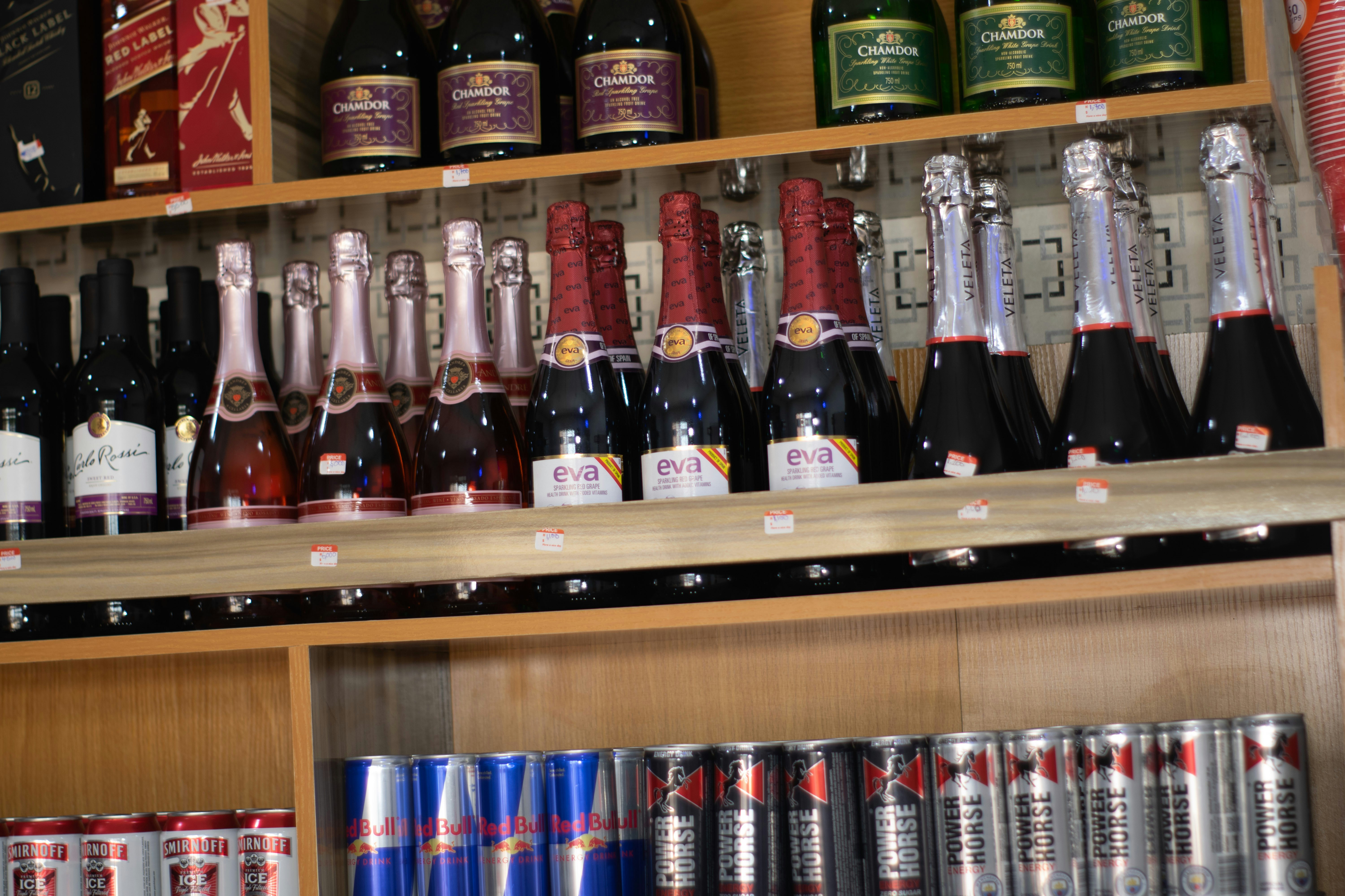 a shelf with bottles of alcohol on it