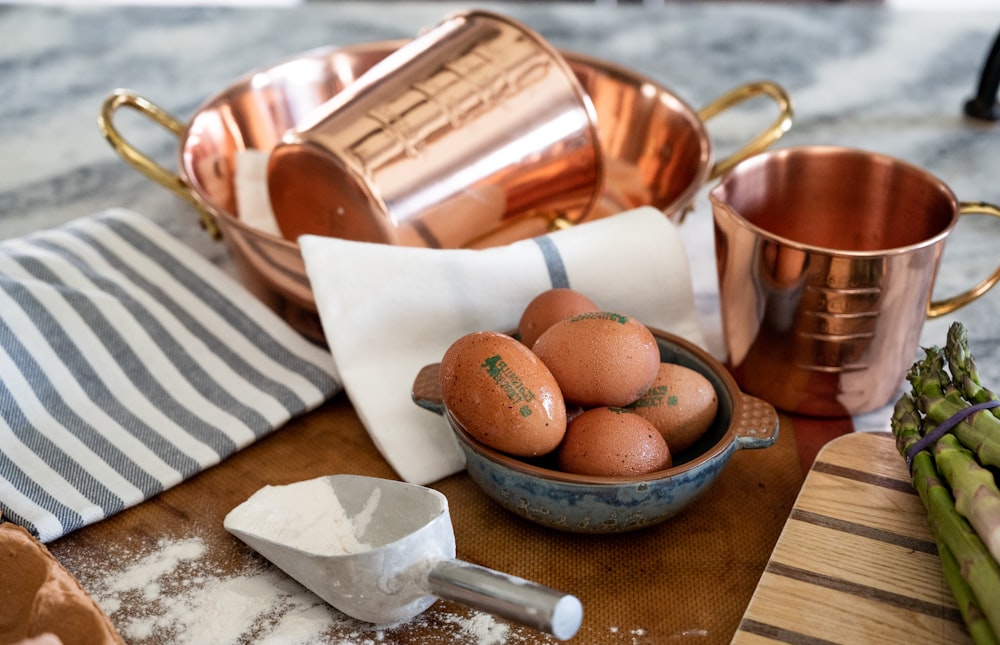 a basket of eggs and a cup of coffee on a table