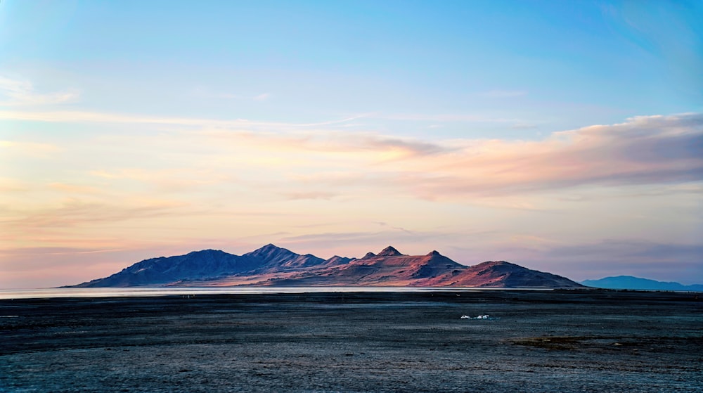 a body of water with mountains in the background