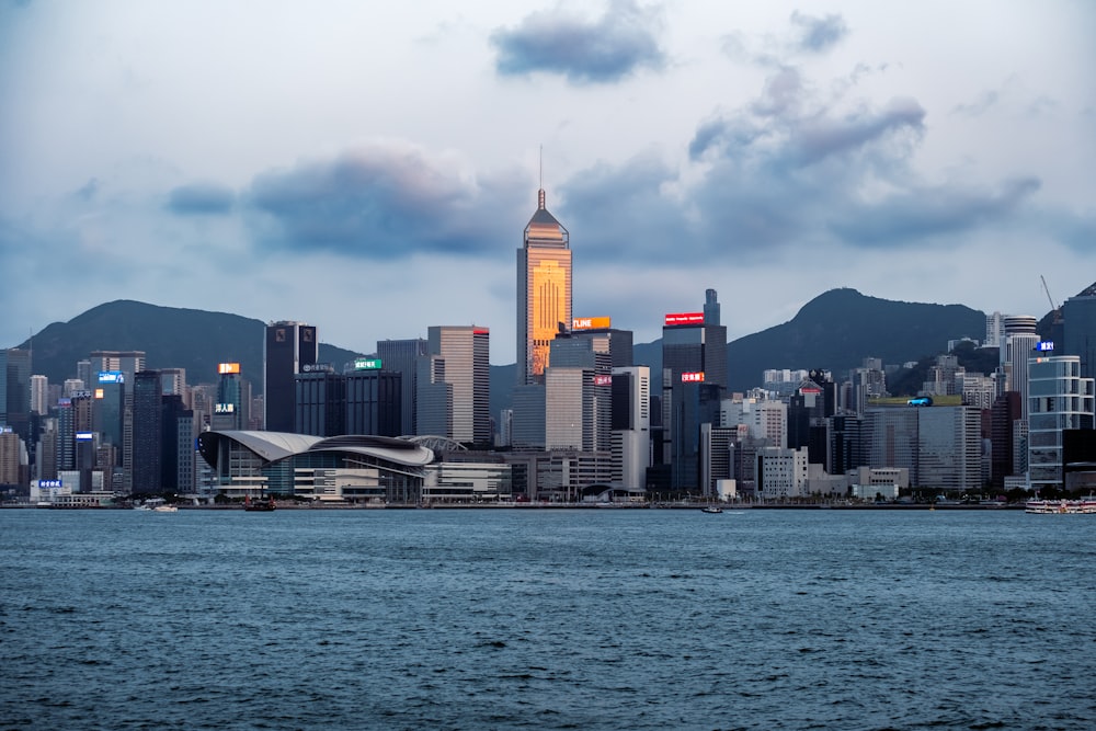 a city skyline with a body of water in the foreground