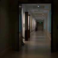 Peaceful hallway lined with calming artwork leading to treatment rooms.