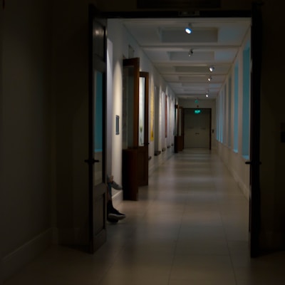 A serene hospital corridor bathed in soft red lighting, evoking warmth and care.