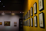 Sleek gallery wall showcasing colorful mixed-media pieces under soft lighting.