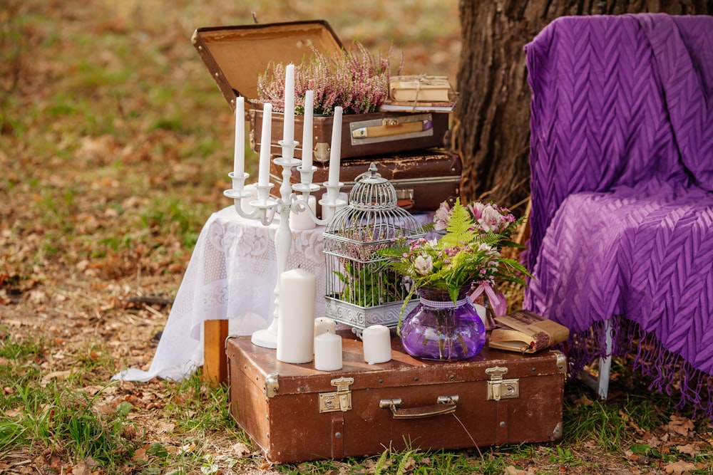 a suitcase with candles and flowers in it