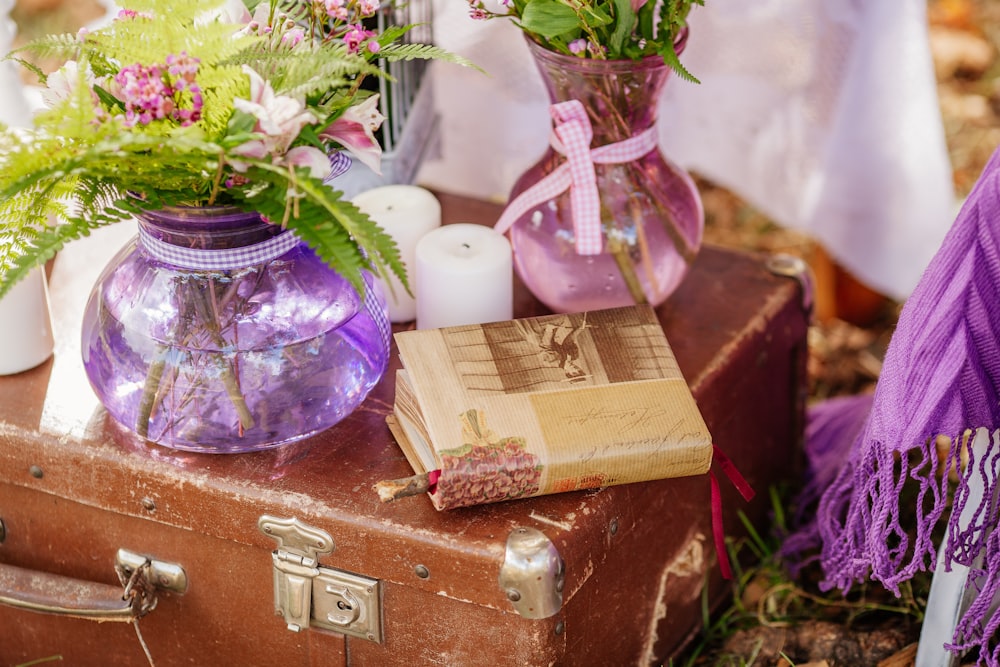 a suitcase with a book and flowers