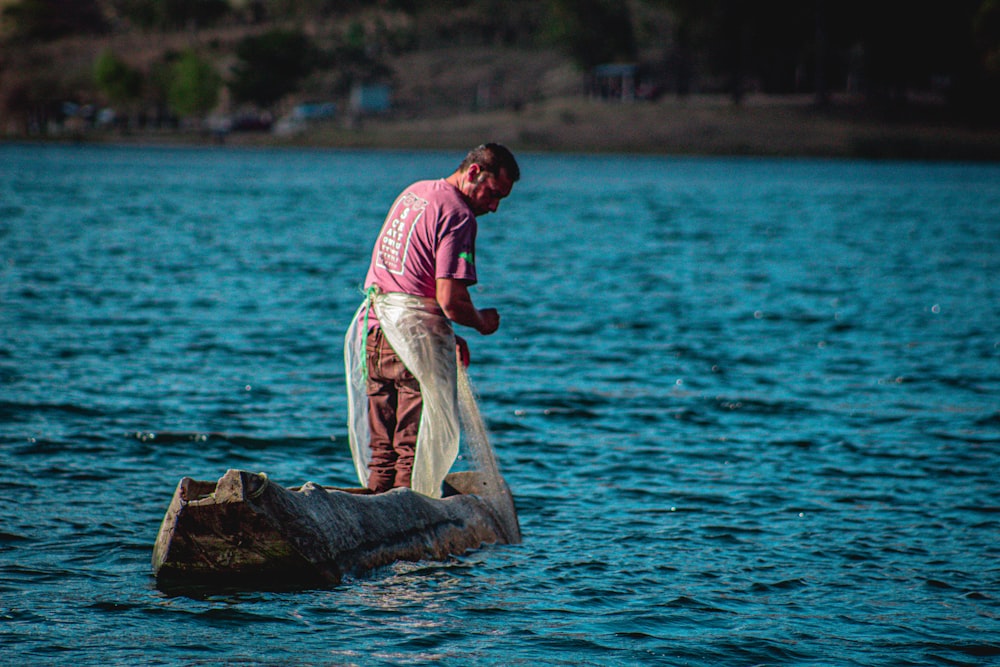 a man standing on a rock in the water