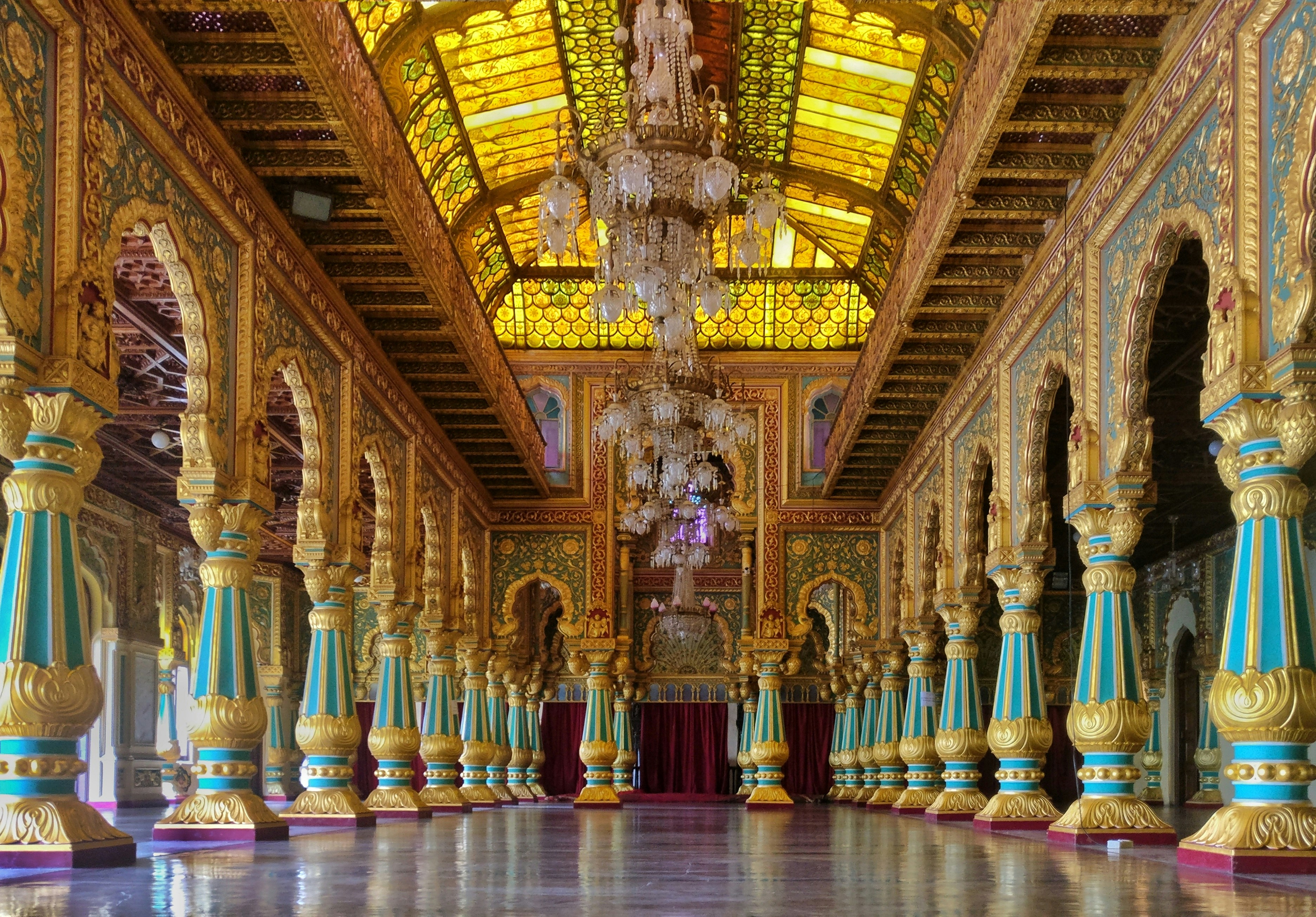 a large ornate room with colorful pillars, The Royal architecture of Mysore Palace