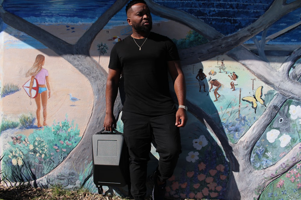 a person standing in front of a wall with graffiti