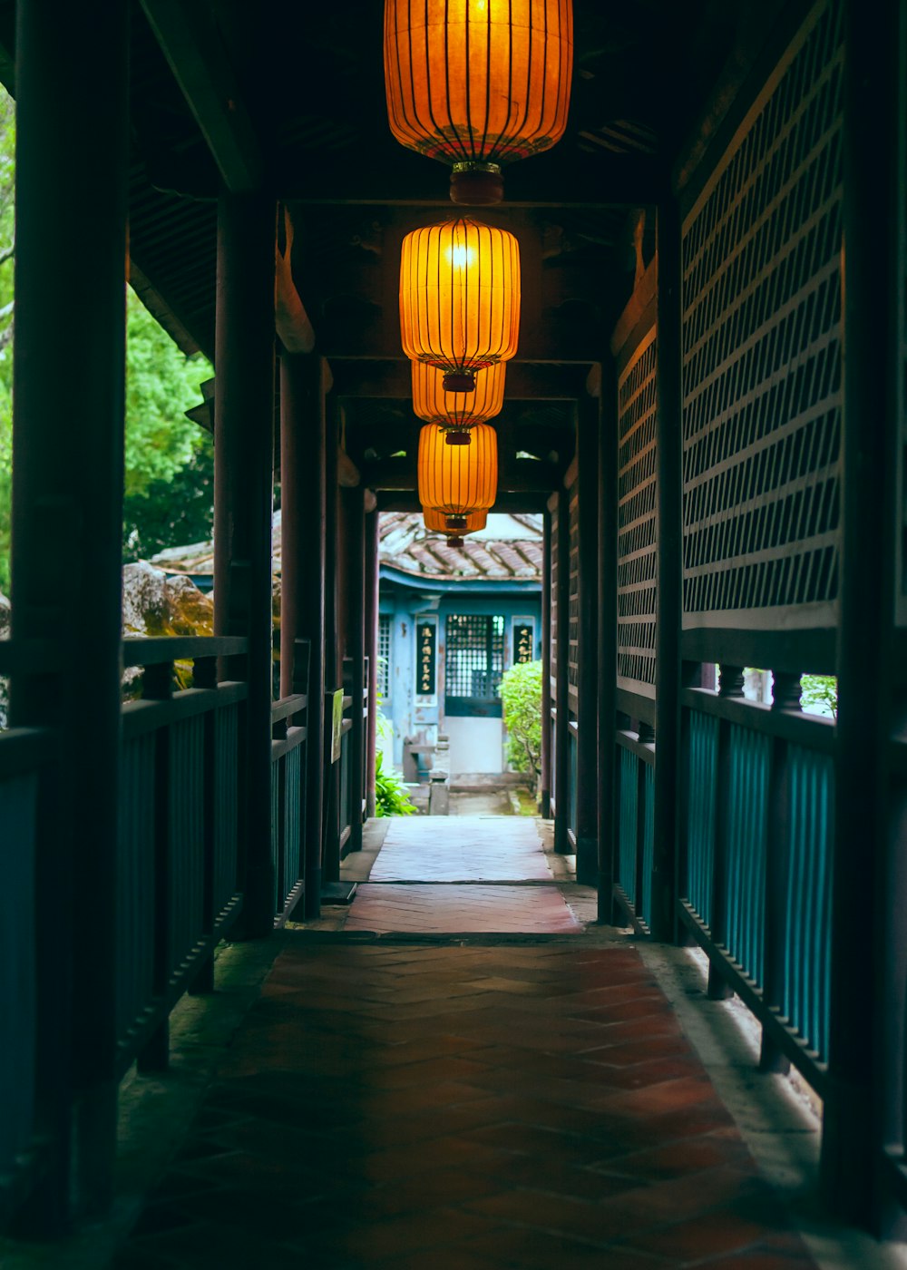 a walkway with a row of lamps