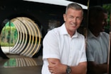 a man smiling with his arms crossed