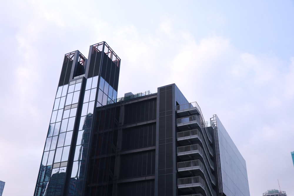 a few skyscrapers with a cloudy sky