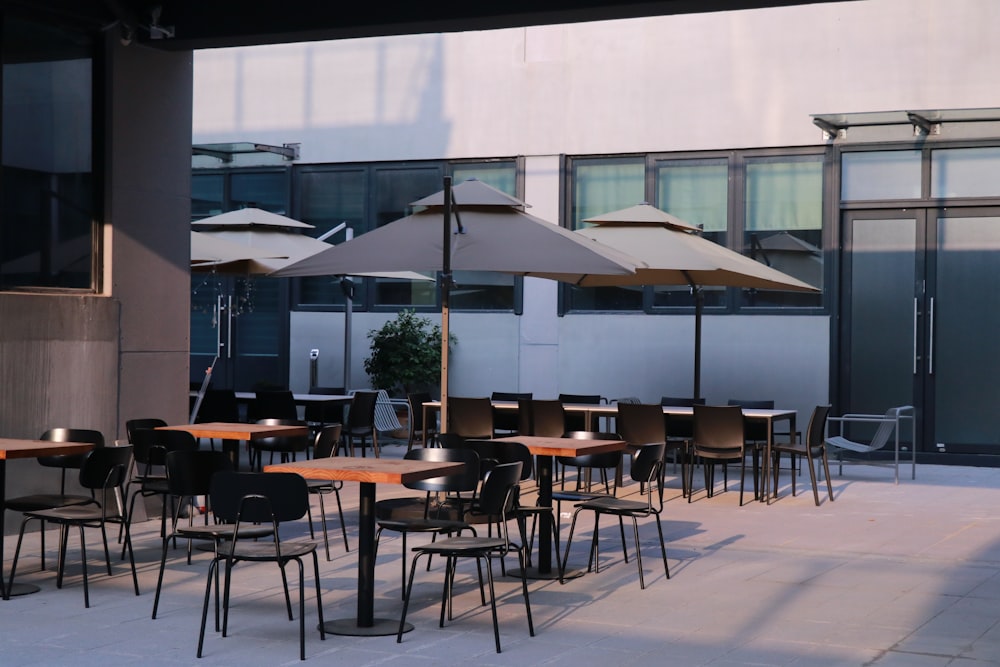 a group of tables and chairs outside a building