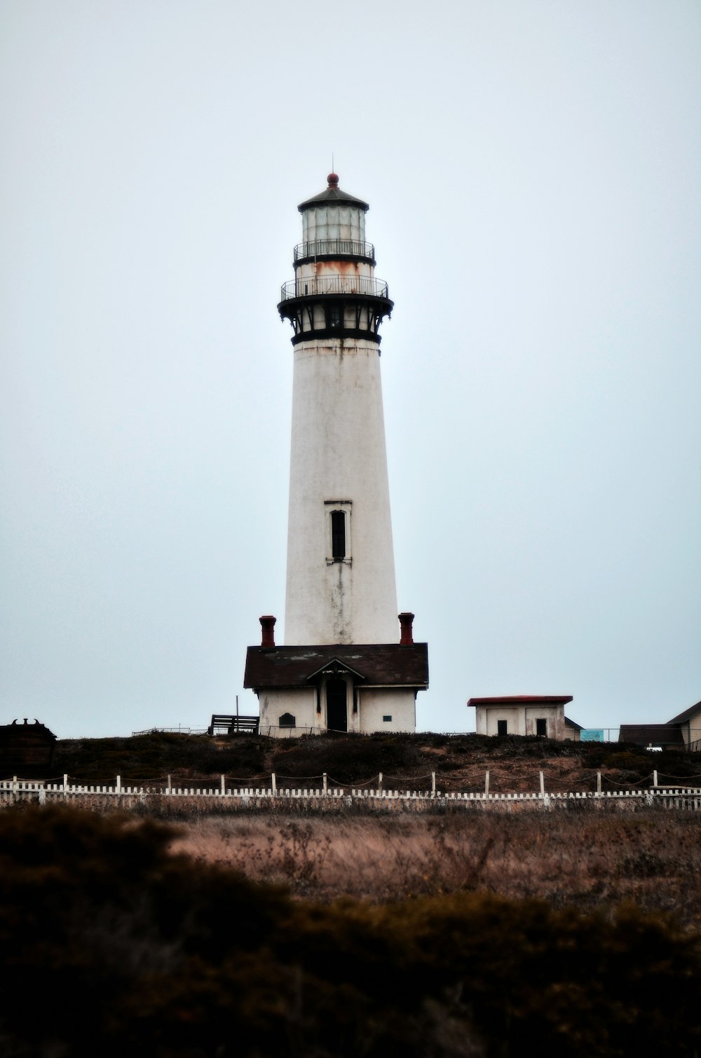 a lighthouse with a building in the background